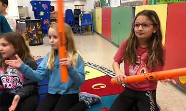  children playing with boomwhackers