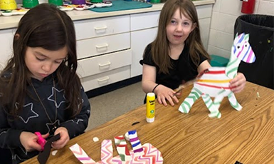  students work on projects in art class