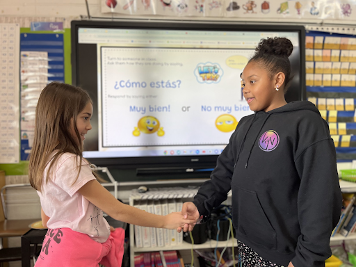  Second Grade Students practice greetings during Spanish Class. 
